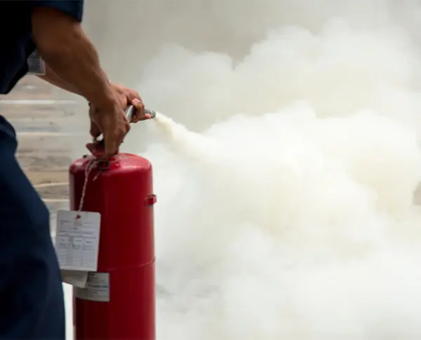 man handling a fire extinguisher