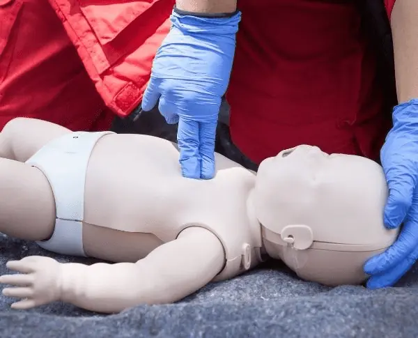 Doing CPR on a baby doll